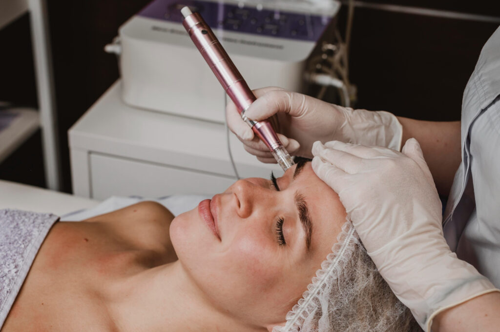 Specialist hands doing Hydrafacial MD on client face