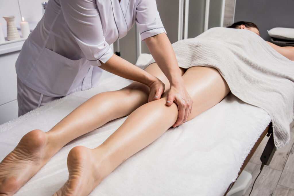 Specialist hands on patient leg on medical spa