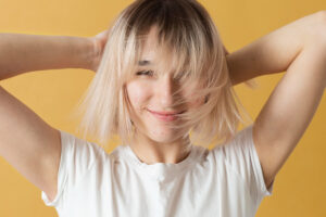 Acne scars removal blonde girl yellow background