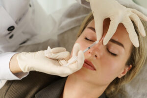 Dermal fillers for forehead wrinkles on woman skin
