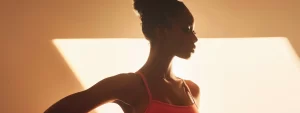 a woman standing confidently, with a sculpted silhouette, showcasing the results of non-surgical body sculpting.